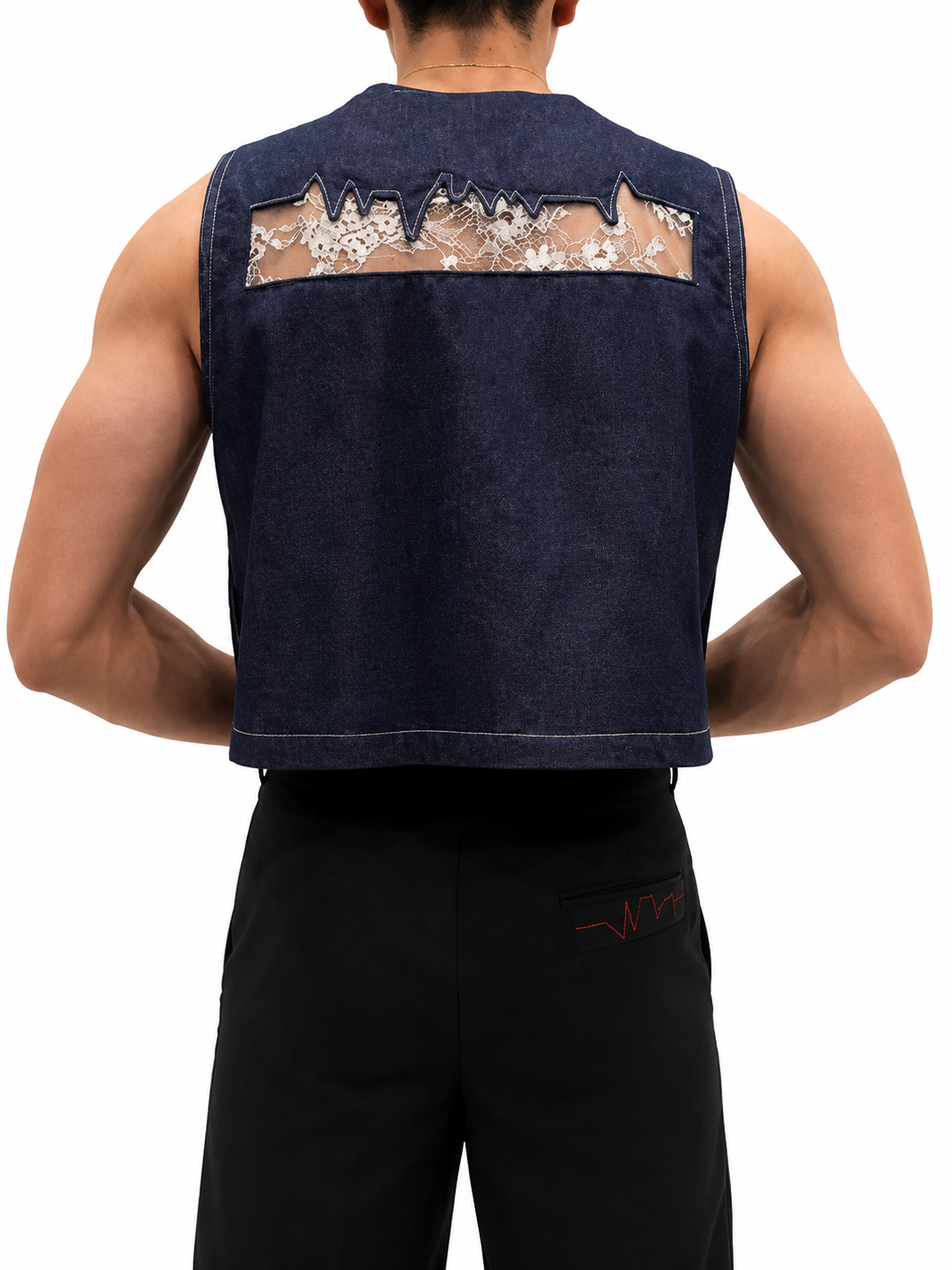 Back view of navy sleeveless denim utility vest featuring a floral lace back panel and contrast topstitching.